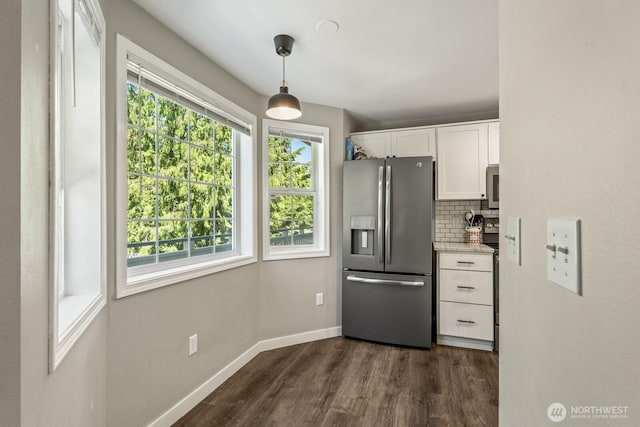 13629 26th Pl W Unit B104, Lynnwood, WA 98087 - kitchen featuring appliances with stainless steel finishes, white cabinets, dark wood-style flooring, backsplash, and baseboards