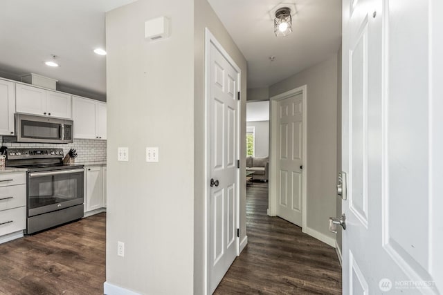 13629 26th Pl W Unit B104, Lynnwood, WA 98087 - kitchen with stainless steel appliances, dark wood-style floors, white cabinetry, backsplash, and recessed lighting