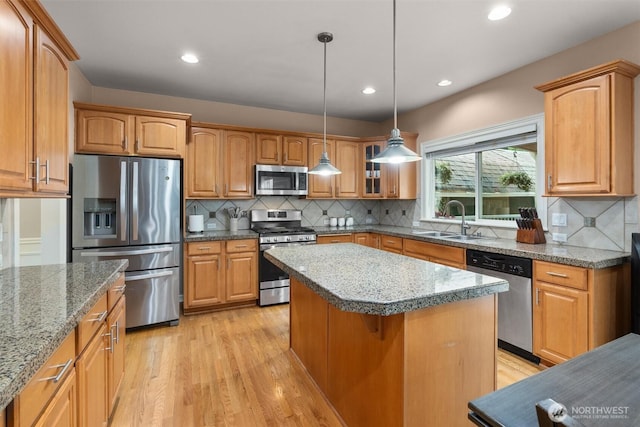 13327 SE 279th Pl, Kent, WA 98042 - kitchen with appliances with stainless steel finishes, a sink, light wood-type flooring, a center island, and tasteful backsplash