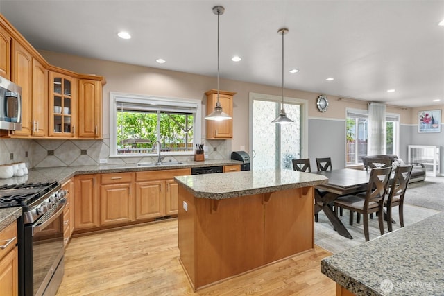 13327 SE 279th Pl, Kent, WA 98042 - kitchen featuring a sink, gas stove, a kitchen island, tasteful backsplash, and glass insert cabinets