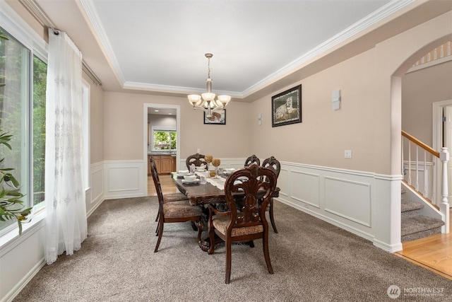 13327 SE 279th Pl, Kent, WA 98042 - dining area with light colored carpet, arched walkways, a chandelier, ornamental molding, and stairway