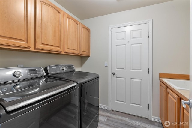 13327 SE 279th Pl, Kent, WA 98042 - washroom featuring washing machine and clothes dryer, light wood-style flooring, and cabinet space
