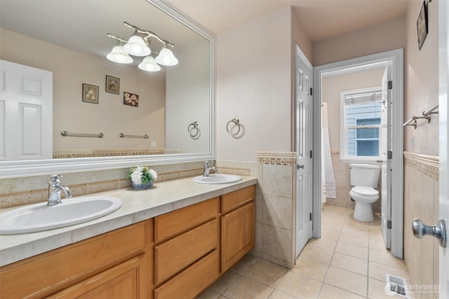 13327 SE 279th Pl, Kent, WA 98042 - full bath with tile patterned floors, tile walls, double vanity, toilet, and a wainscoted wall