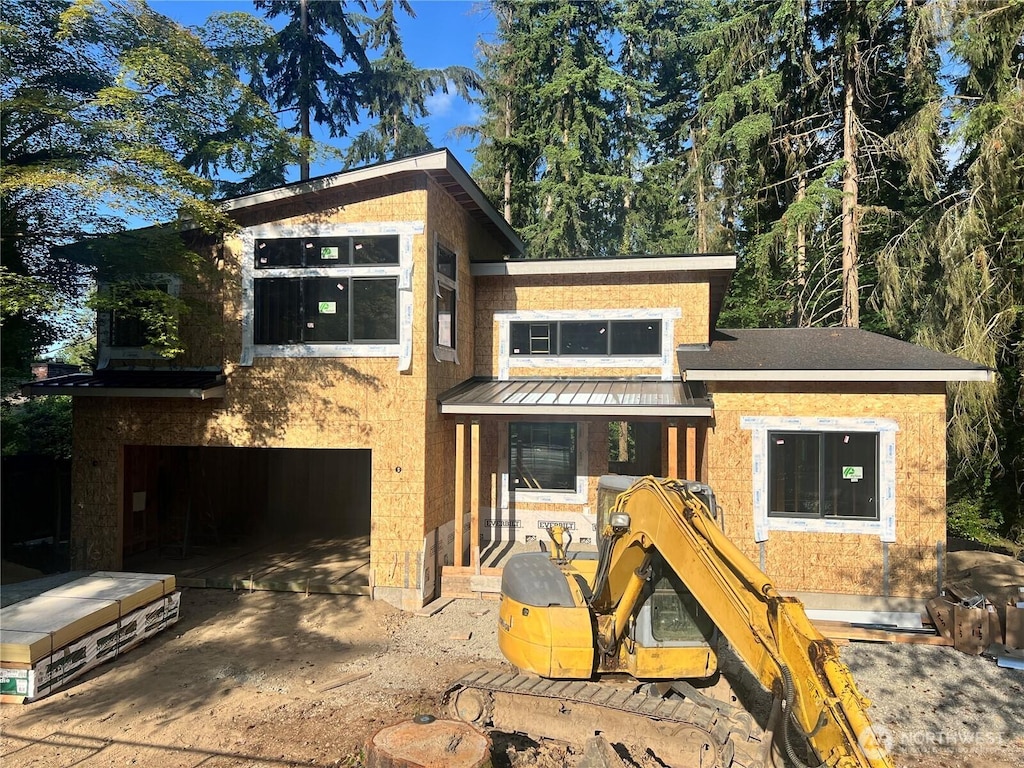 18616 92nd Ave NE, Bothell, WA 98011 - view of front of house featuring a standing seam roof, a garage, metal roof, and concrete driveway
