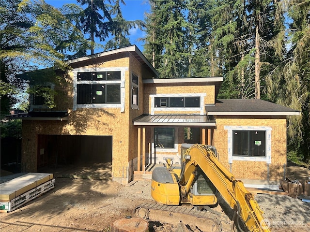 18616 92nd Ave NE, Bothell, WA 98011 - view of front of house featuring a standing seam roof, a garage, metal roof, and concrete driveway