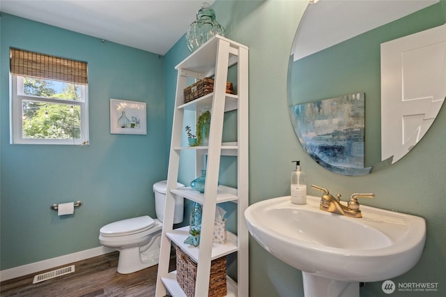 9520 Avon Allen Rd, Bow, WA 98232 - half bath with toilet, a sink, wood finished floors, and baseboards
