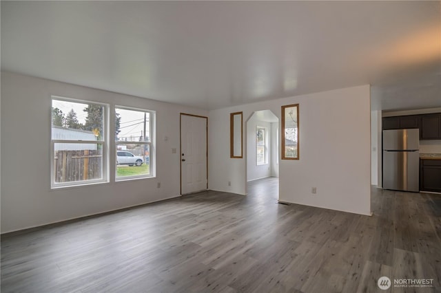 866 112th St S, Parkland, WA 98444 - unfurnished living room featuring wood finished floors and arched walkways