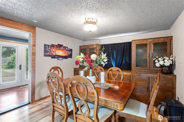 15412 SE 304th Pl, Kent, WA 98042 - dining room with a textured ceiling, light wood-type flooring, and baseboards