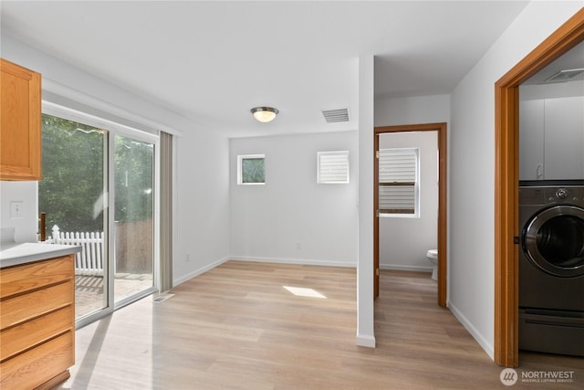 4817 SE 147th Pl, Everett, WA 98208 - laundry area featuring washer / clothes dryer, light wood-style floors, baseboards, and cabinet space