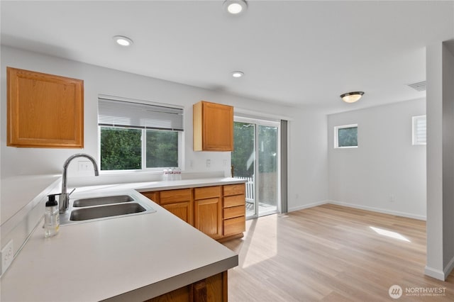 4817 SE 147th Pl, Everett, WA 98208 - kitchen with a sink, light countertops, light wood finished floors, recessed lighting, and baseboards