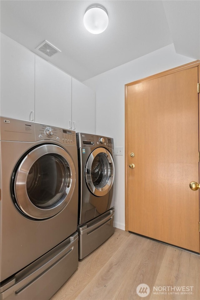 4817 SE 147th Pl, Everett, WA 98208 - laundry room with washer and dryer, cabinet space, and light wood-style flooring