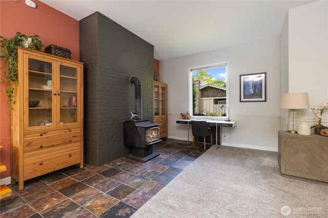 26933 NE Cherry St, Duvall, WA 98019 - office space with stone tile flooring, a wood stove, wainscoting, and baseboards