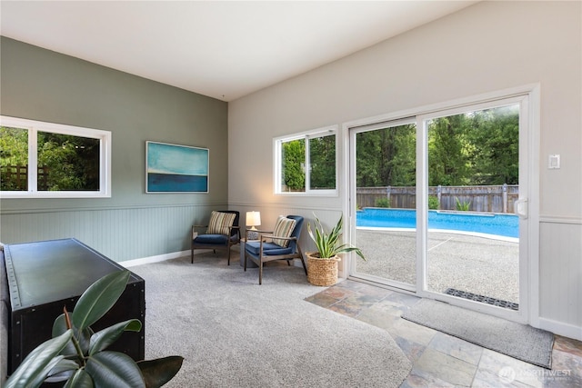 26933 NE Cherry St, Duvall, WA 98019 - living area with stone finish flooring, a wainscoted wall, and baseboards