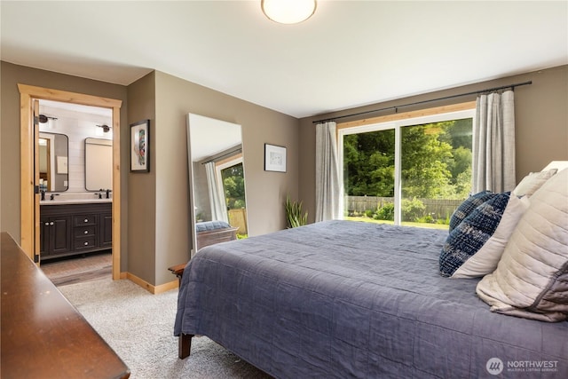 26933 NE Cherry St, Duvall, WA 98019 - bedroom with multiple windows, light carpet, ensuite bathroom, and baseboards