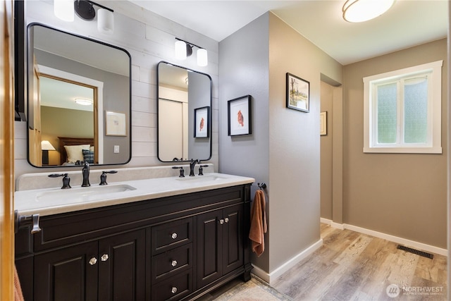 26933 NE Cherry St, Duvall, WA 98019 - full bathroom with double vanity, wood finished floors, and baseboards