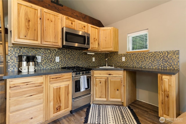 26933 NE Cherry St, Duvall, WA 98019 - kitchen with stainless steel appliances, a sink, dark countertops, light brown cabinetry, and vaulted ceiling