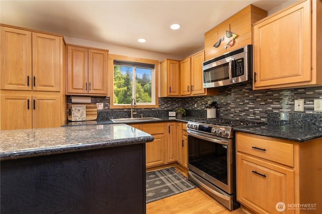 26933 NE Cherry St, Duvall, WA 98019 - kitchen featuring appliances with stainless steel finishes, a sink, light wood-style floors, tasteful backsplash, and recessed lighting