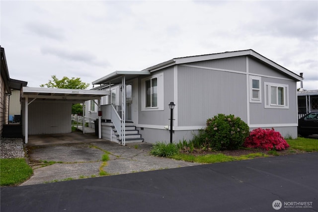 10711 62nd St E Unit 81A, Puyallup, WA 98372 - view of property exterior featuring driveway and an attached carport