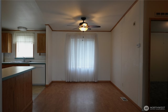 10711 62nd St E Unit 81A, Puyallup, WA 98372 - kitchen with white dishwasher, ceiling fan, light wood-type flooring, ornamental molding, and a sink