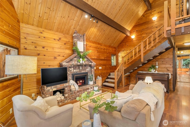7755 NE Seawind Ave, Poulsbo, WA 98370 - living area with wood finished floors, wooden walls, wood ceiling, stairway, and a fireplace