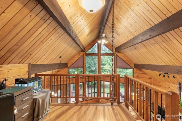 7755 NE Seawind Ave, Poulsbo, WA 98370 - interior space featuring wood finished floors, wood walls, wooden ceiling with exposed beams, and high vaulted ceiling