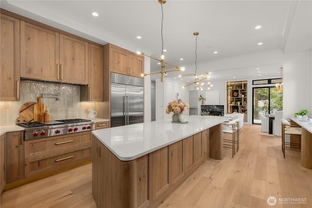 7116 NE 119th Ln, Kirkland, WA 98034 - kitchen featuring appliances with stainless steel finishes, backsplash, light wood finished floors, light countertops, and recessed lighting