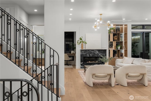 7116 NE 119th Ln, Kirkland, WA 98034 - living room featuring wood finished floors, recessed lighting, a premium fireplace, a chandelier, and stairway