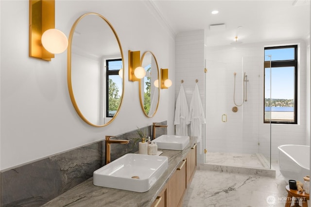 7116 NE 119th Ln, Kirkland, WA 98034 - bathroom featuring a stall shower, marble finish flooring, double vanity, a soaking tub, and ornamental molding