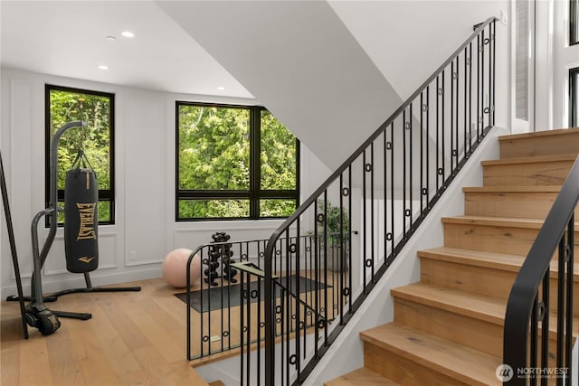 7116 NE 119th Ln, Kirkland, WA 98034 - staircase featuring hardwood / wood-style floors, plenty of natural light, recessed lighting, and a decorative wall