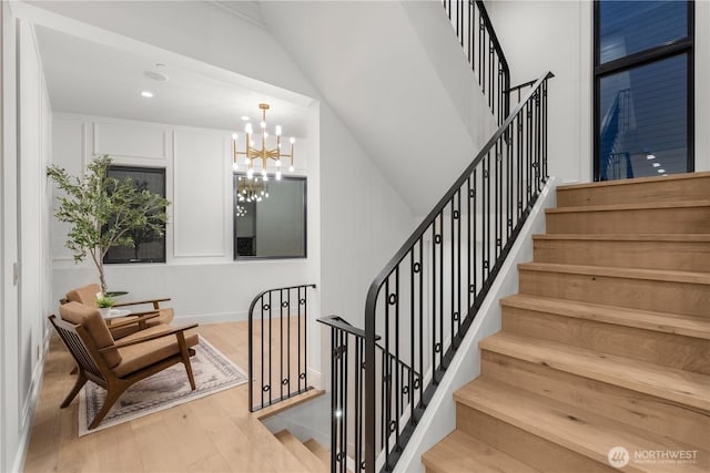 7116 NE 119th Ln, Kirkland, WA 98034 - stairway featuring wood finished floors and a chandelier