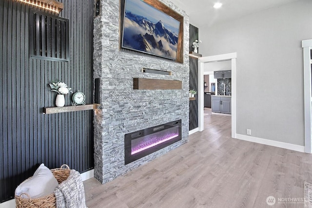 1630 Hillcrest Ave, Enumclaw, WA 98022 - living room with wood finished floors, a stone fireplace, and baseboards