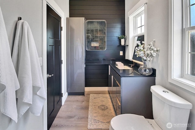 1630 Hillcrest Ave, Enumclaw, WA 98022 - bathroom with toilet, wood finished floors, vanity, and wood walls