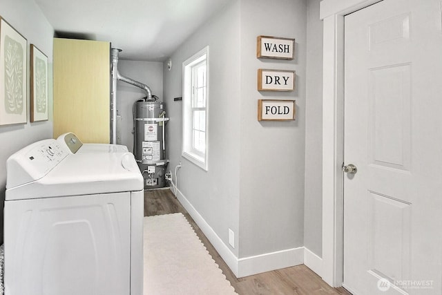 1630 Hillcrest Ave, Enumclaw, WA 98022 - laundry area with washing machine and dryer, water heater, wood finished floors, and baseboards