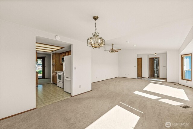 6410 151st Ave E, Sumner, WA 98390 - unfurnished living room with a chandelier, baseboards, light carpet, and ceiling fan