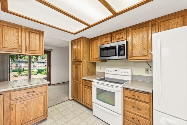 6410 151st Ave E, Sumner, WA 98390 - kitchen featuring white appliances, light countertops, light flooring, and brown cabinets