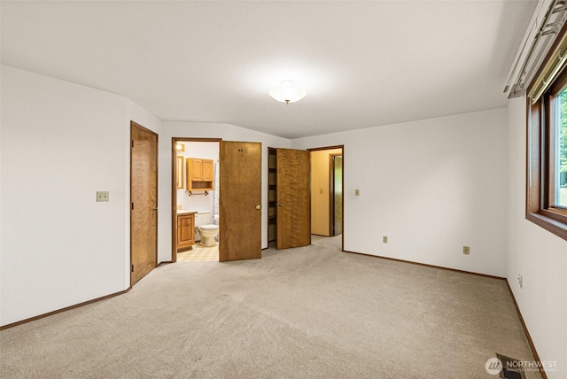 6410 151st Ave E, Sumner, WA 98390 - unfurnished bedroom with light carpet, ensuite bath, and baseboards