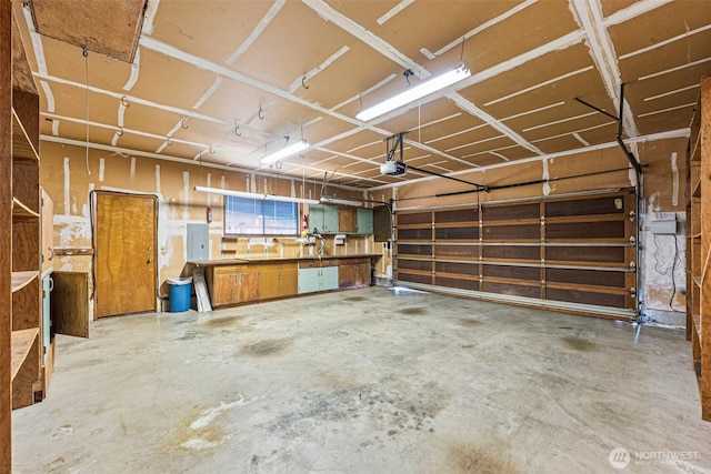 6410 151st Ave E, Sumner, WA 98390 - garage featuring electric panel and a garage door opener