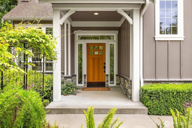 3029 Yankee Girl Cir NE, Bainbridge Island, WA 98110 - doorway to property with stone siding, board and batten siding, roof with shingles, and a chimney