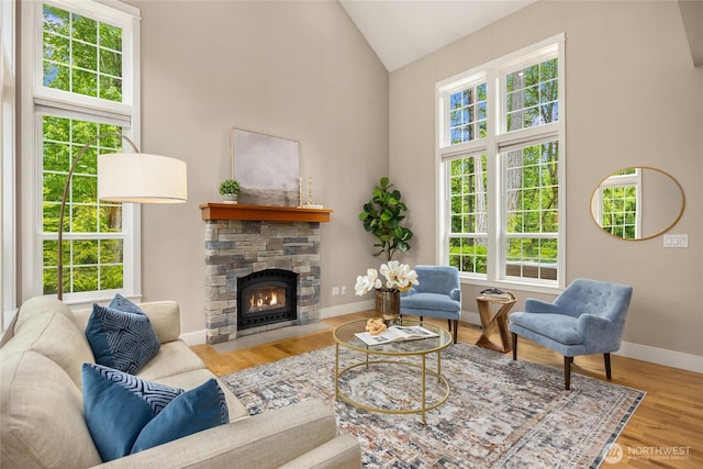 3029 Yankee Girl Cir NE, Bainbridge Island, WA 98110 - living area featuring a fireplace, wood finished floors, baseboards, and high vaulted ceiling