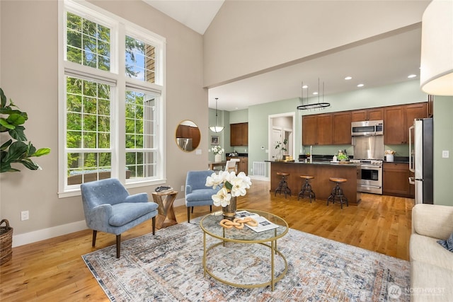 3029 Yankee Girl Cir NE, Bainbridge Island, WA 98110 - living area featuring light wood-style floors, plenty of natural light, baseboards, recessed lighting, and high vaulted ceiling