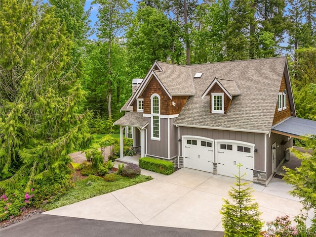 3029 Yankee Girl Cir NE, Bainbridge Island, WA 98110 - view of front of house with a shingled roof, driveway, board and batten siding, and a chimney