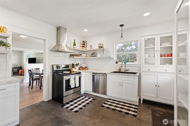 1102 Tecumseh St, Aberdeen, WA 98520 - kitchen with stainless steel appliances, wall chimney range hood, a sink, open shelves, and recessed lighting