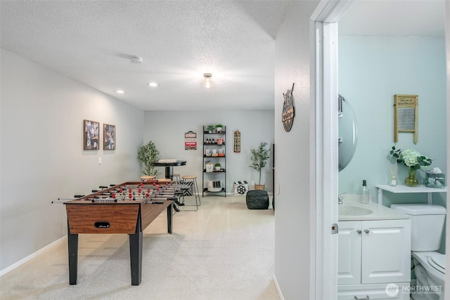 5907 N 31st St, Tacoma, WA 98407 - recreation room with light colored carpet, a sink, a textured ceiling, and recessed lighting