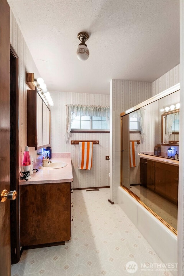 1487 Centralia Alpha Rd, Chehalis, WA 98532 - full bathroom with wallpapered walls, vanity, shower / bath combination with glass door, a textured ceiling, and tile patterned floors