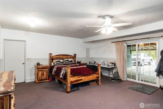 1487 Centralia Alpha Rd, Chehalis, WA 98532 - bedroom featuring access to exterior, carpet, wainscoting, a ceiling fan, and electric panel