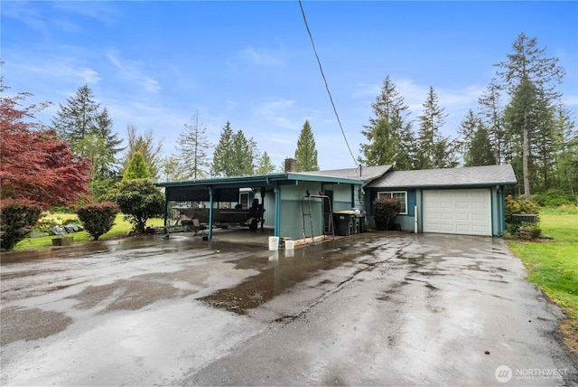 1487 Centralia Alpha Rd, Chehalis, WA 98532 - ranch-style house with asphalt driveway, a carport, an attached garage, and a chimney