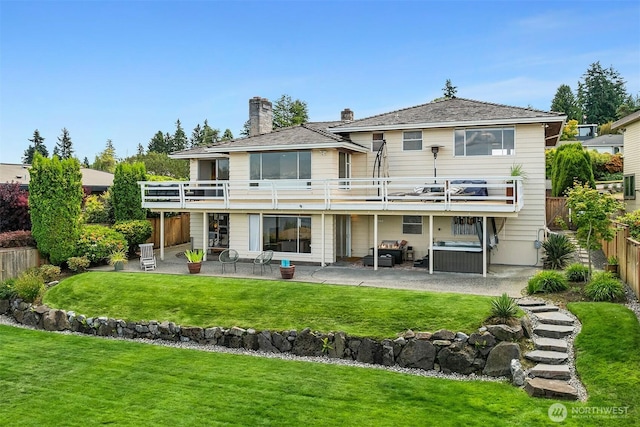 4910 NE 86th St, Seattle, WA 98115 - back of property featuring a balcony, a patio area, a fenced backyard, and a chimney