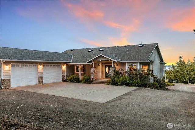 8151 E Seaview Dr, Port Orchard, WA 98366 - view of front of home with an attached garage, driveway, stone siding, and a shingled roof