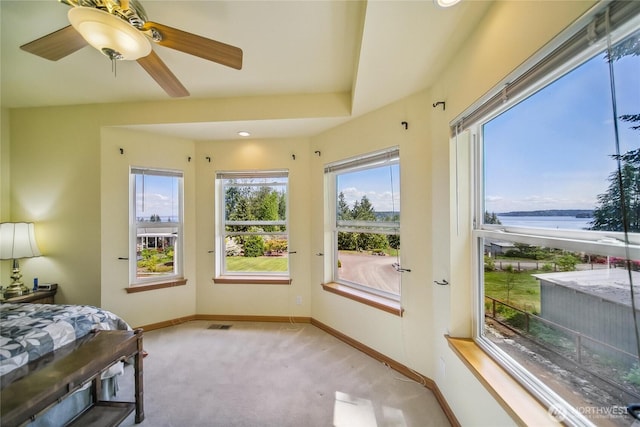 8151 E Seaview Dr, Port Orchard, WA 98366 - bedroom featuring carpet floors, baseboards, a water view, and a ceiling fan
