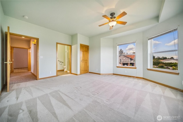 8151 E Seaview Dr, Port Orchard, WA 98366 - unfurnished bedroom featuring light carpet, baseboards, ensuite bathroom, and ceiling fan